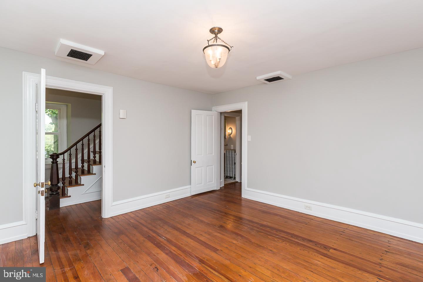 337 Righters Mill Road Gladwyne, PA 19035 - Photo 9 of 41 a view of an empty room with wooden floor and a window