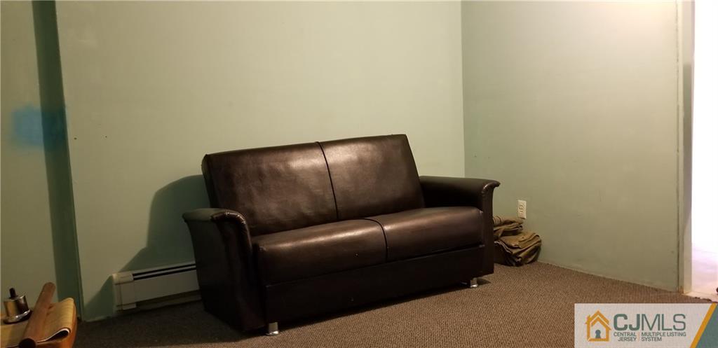 901 A Hermann Road North Brunswick, NJ 08902 - Photo 14 of 21 a couch sitting in a living room with a chair