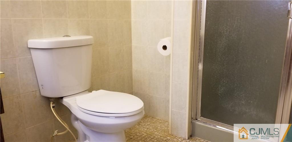 901 A Hermann Road North Brunswick, NJ 08902 - Photo 18 of 21 a white toilet sitting next to a bathroom sink