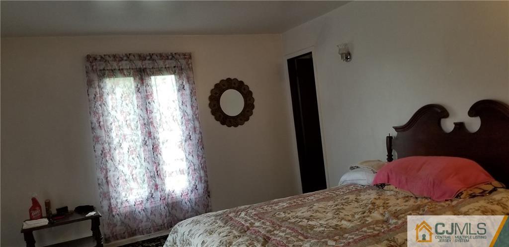 901 A Hermann Road North Brunswick, NJ 08902 - Photo 6 of 21 a bedroom with a bed and window
