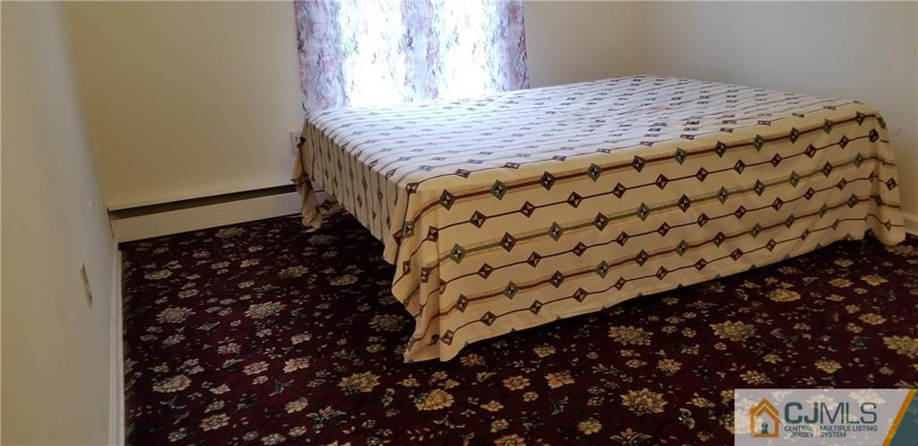 901 A Hermann Road North Brunswick, NJ 08902 - Photo 7 of 21 a bed sitting in a bedroom next to a window
