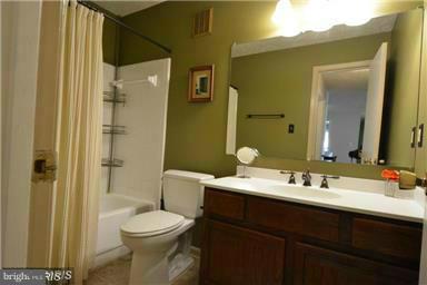 10169 Oakton Terrace Road, Unit 10169 Oakton, VA 22124 - Photo 4 of 14 a bathroom with a sink a toilet and shower