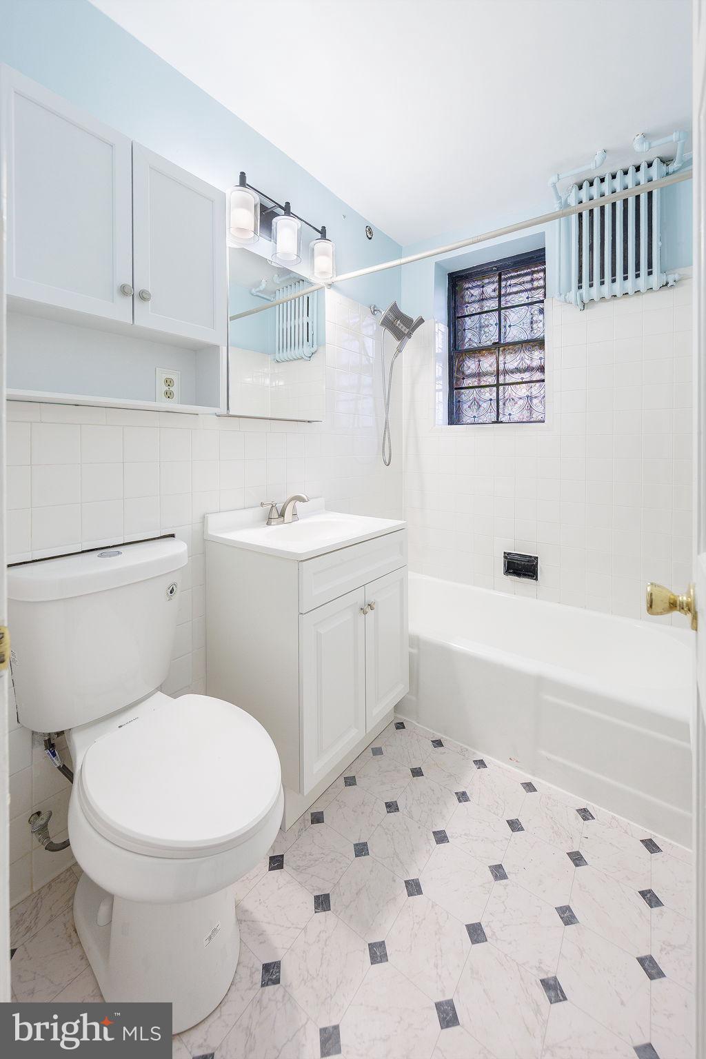 1446 Tuckerman Street Northwest, Unit A6 Washington, DC 20011 - Photo 13 of 25 a bathroom with a sink a toilet and bathtub