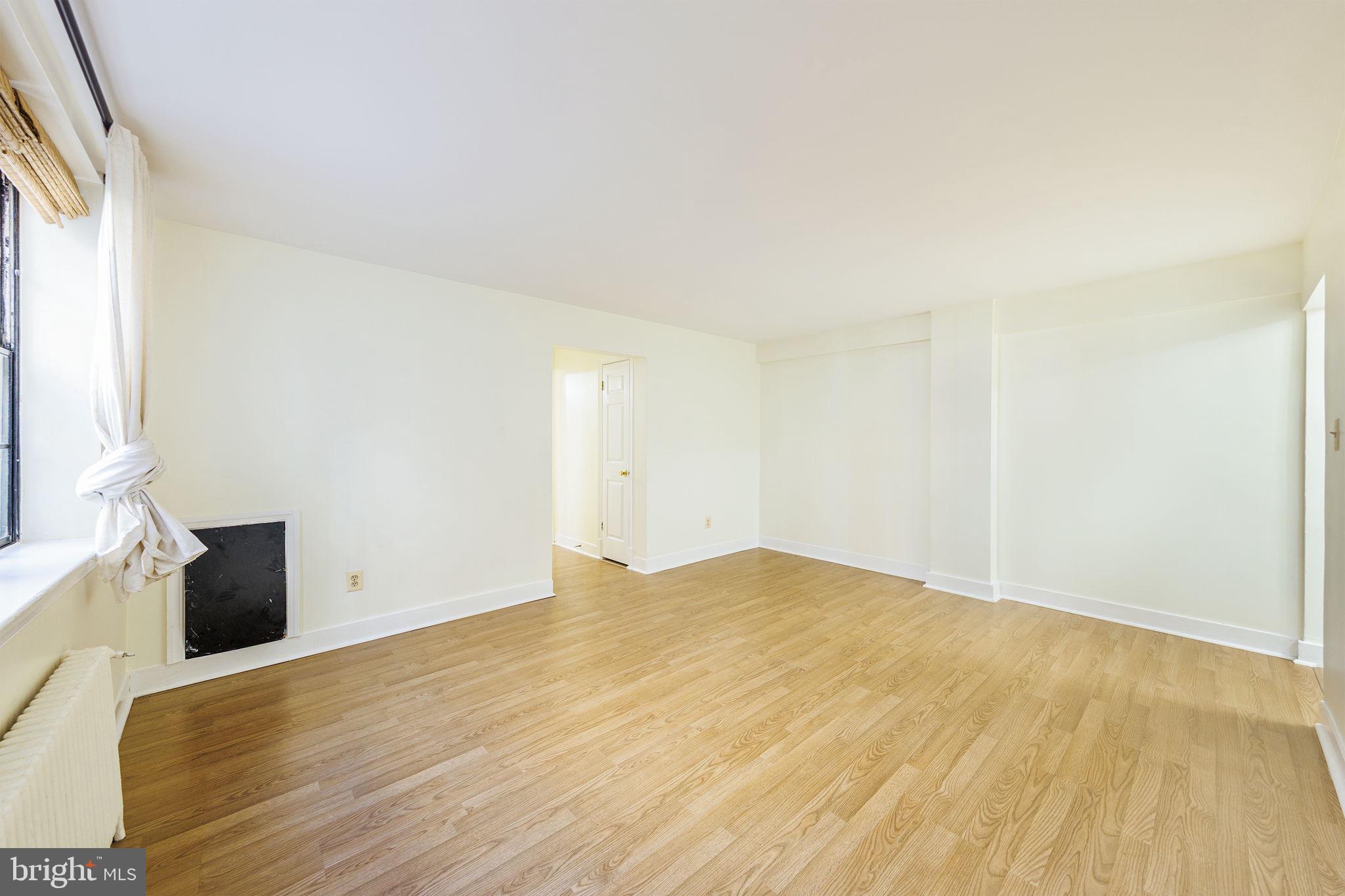 1446 Tuckerman Street Northwest, Unit A6 Washington, DC 20011 - Photo 16 of 25 a view of empty room with wooden floor and fan