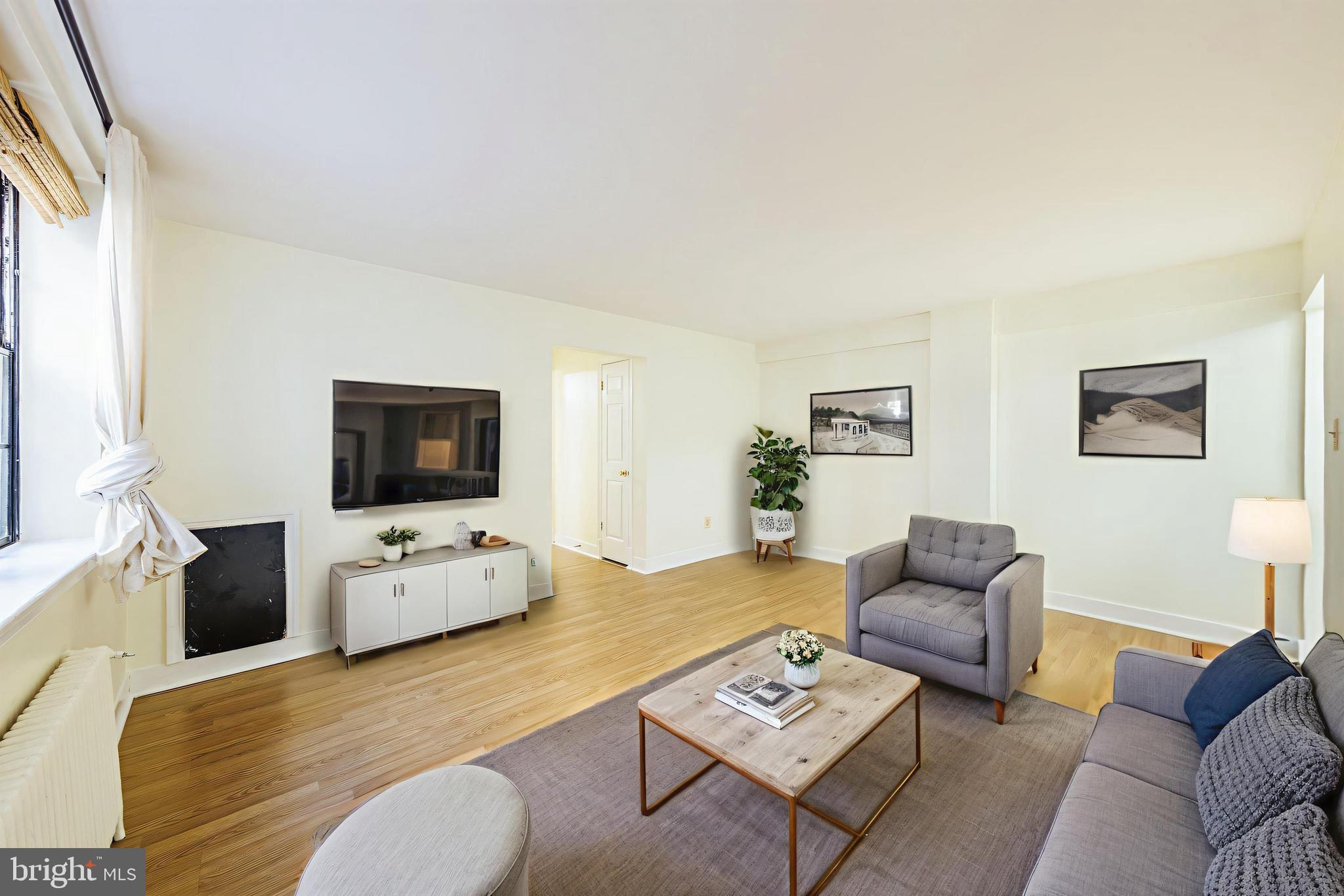 1446 Tuckerman Street Northwest, Unit A6 Washington, DC 20011 - Photo 4 of 25 a living room with furniture and a flat screen tv