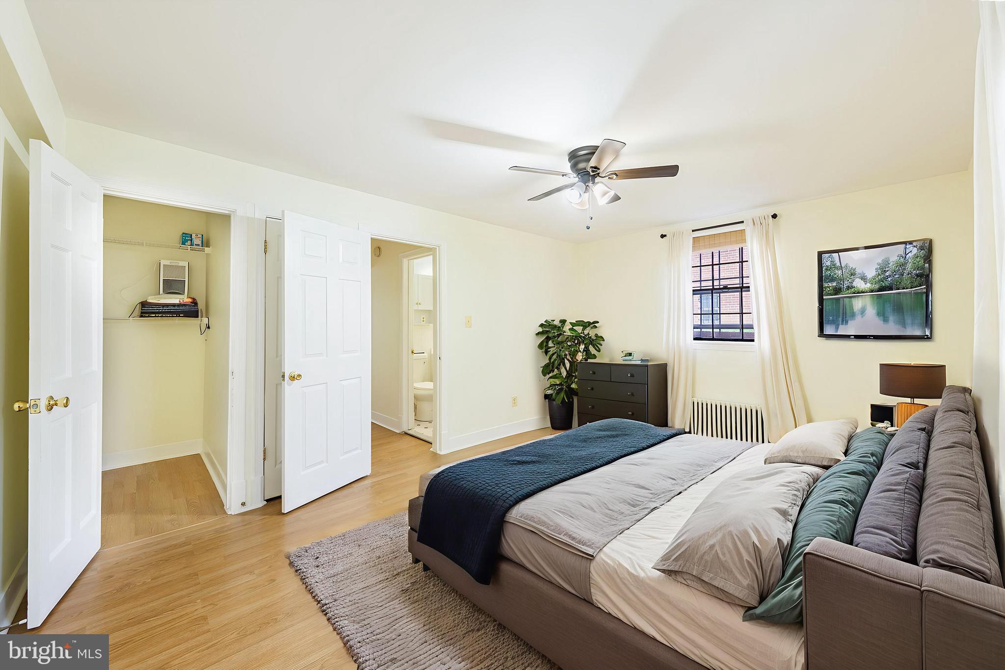 1446 Tuckerman Street Northwest, Unit A6 Washington, DC 20011 - Photo 6 of 25 a bedroom with a large bed and a chandelier