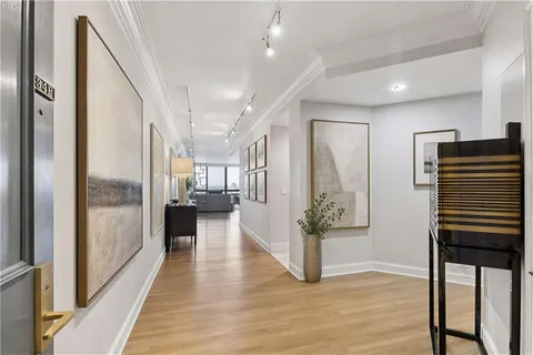 a view of an entryway with wooden floor and windows