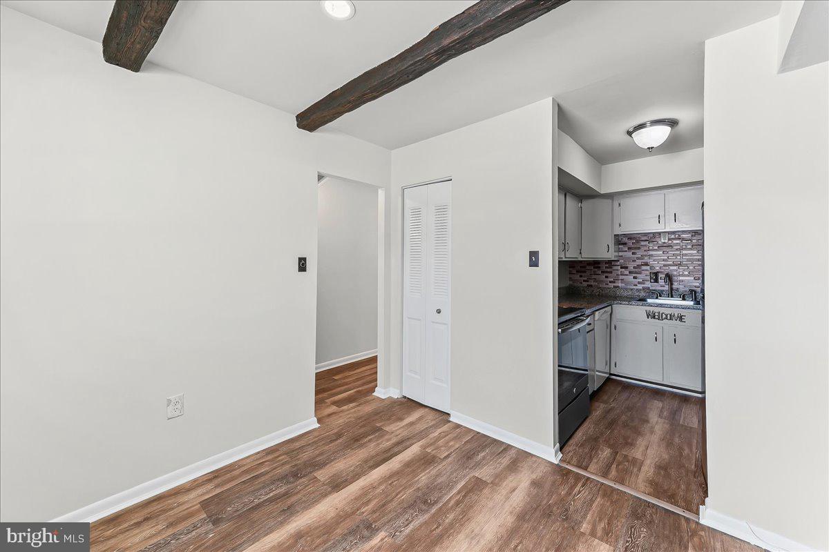 54 Norwood House Road, Unit 34 Downingtown, PA 19335 - Photo 4 of 21 a view of a kitchen with white cabinets and wooden floor