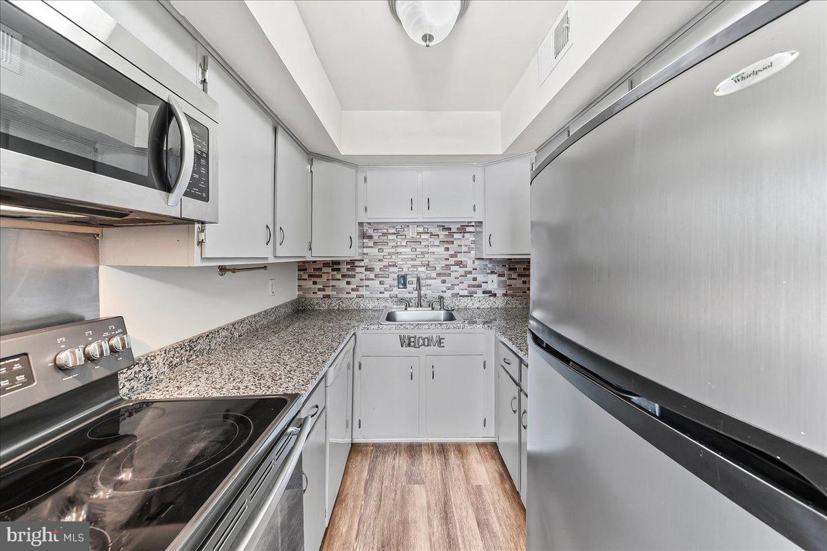 54 Norwood House Road, Unit 34 Downingtown, PA 19335 - Photo 5 of 21 a kitchen with stainless steel appliances granite countertop a stove and a sink