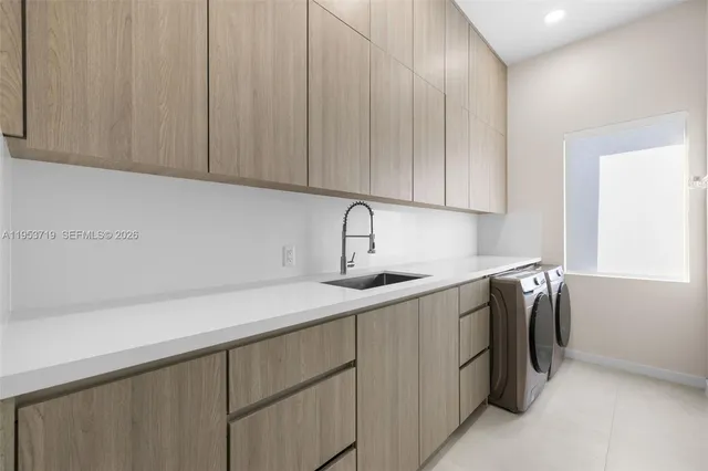 a kitchen with a sink cabinets and stainless steel appliances