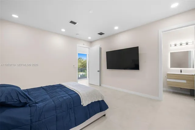 a bathroom with a granite countertop sink a toilet a mirror and shower