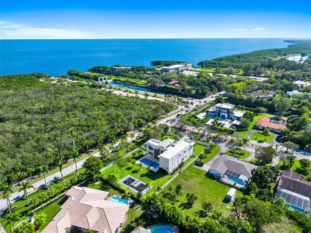 an aerial view of a house with swimming pool and garden
