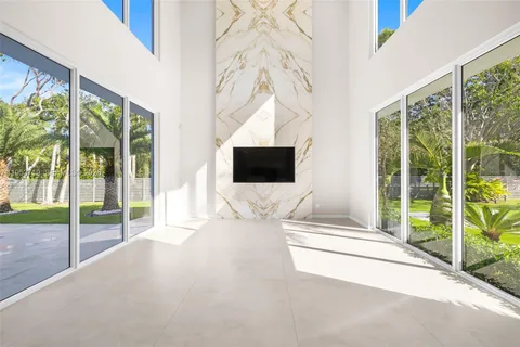 a bedroom with a bed and large window