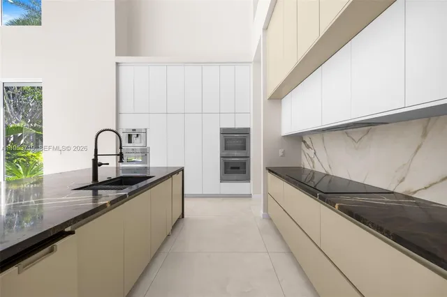 a large kitchen with a sink and cabinets