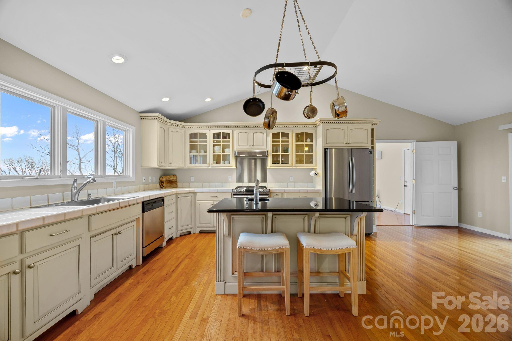 995 Towery Trace Road Ellenboro, NC 28040 - Photo 17 of 40 a kitchen with stainless steel appliances a dining table chairs and wooden floor