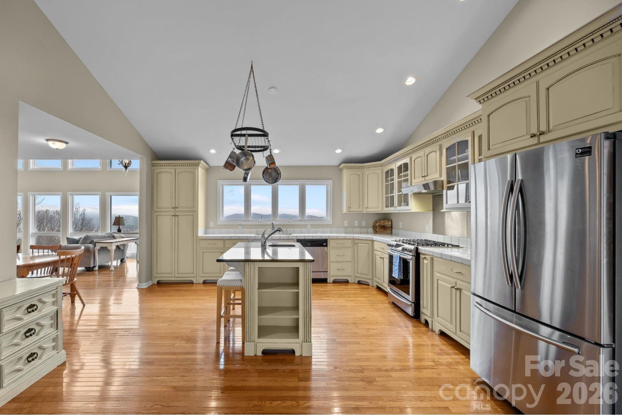 995 Towery Trace Road Ellenboro, NC 28040 - Photo 2 of 40 a kitchen with stainless steel appliances granite countertop a refrigerator a stove top oven a sink dishwasher and white cabinets with wooden floor
