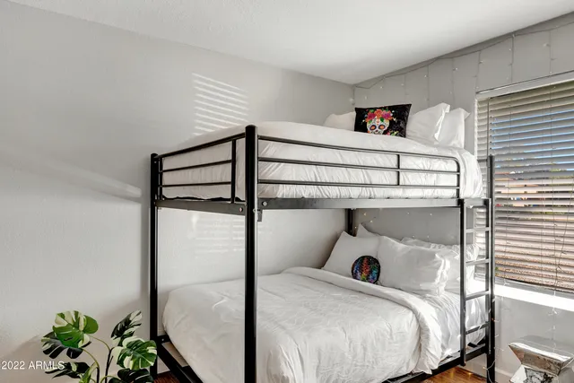 a bedroom with a bed and a potted plant