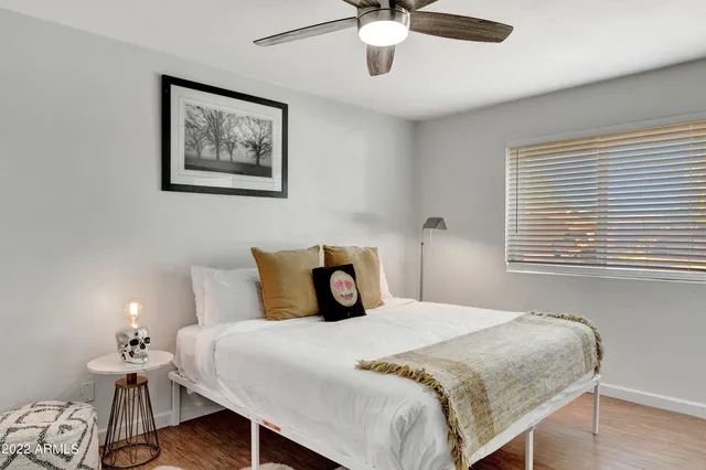 a bedroom with a bed and a table