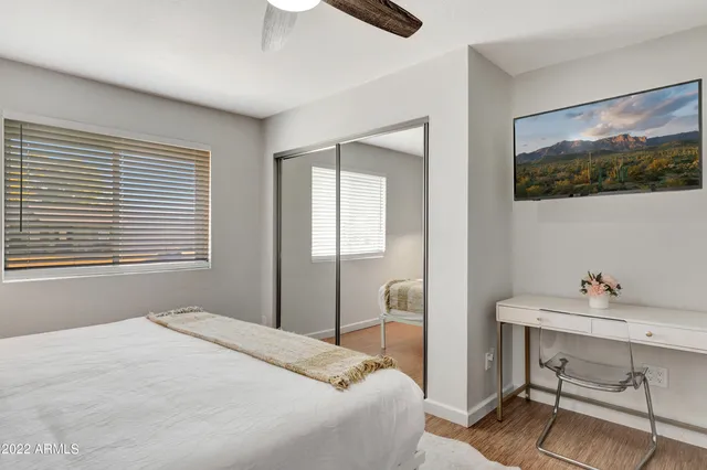 a bedroom with a bed and a table