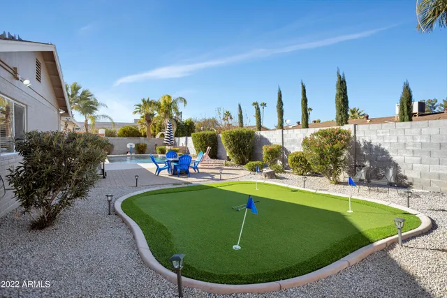 a view of a swimming pool with outdoor seating