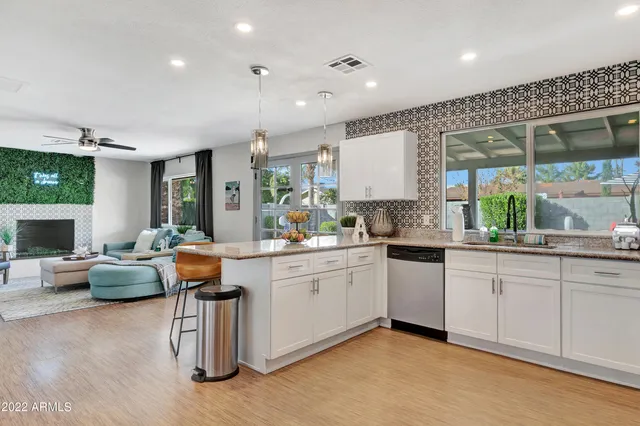 a kitchen with sink refrigerator and couches