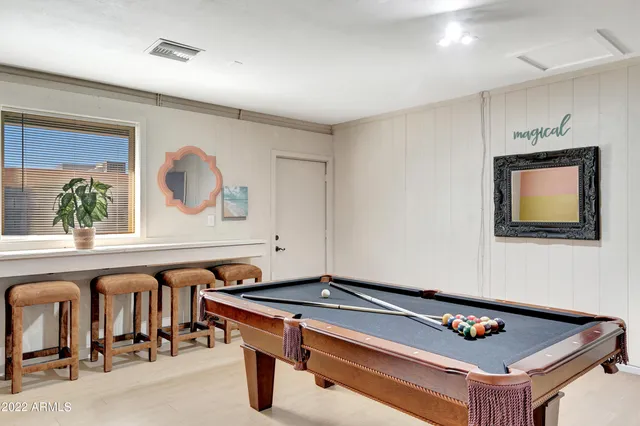 a room with furniture pool table and flat screen tv