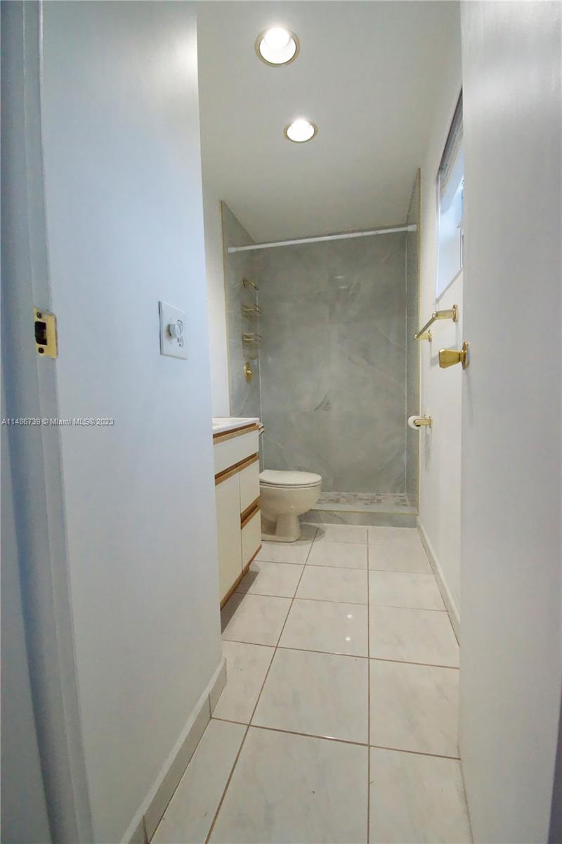 6560 Northwest 30th Street Sunrise, FL 33313 - Photo 12 of 46 a bathroom with a toilet and a shower