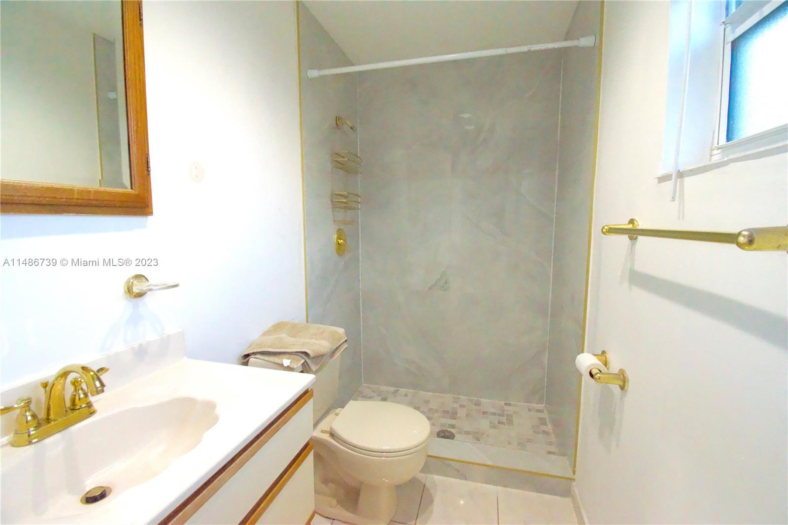 6560 Northwest 30th Street Sunrise, FL 33313 - Photo 13 of 46 a bathroom with a sink toilet and shower