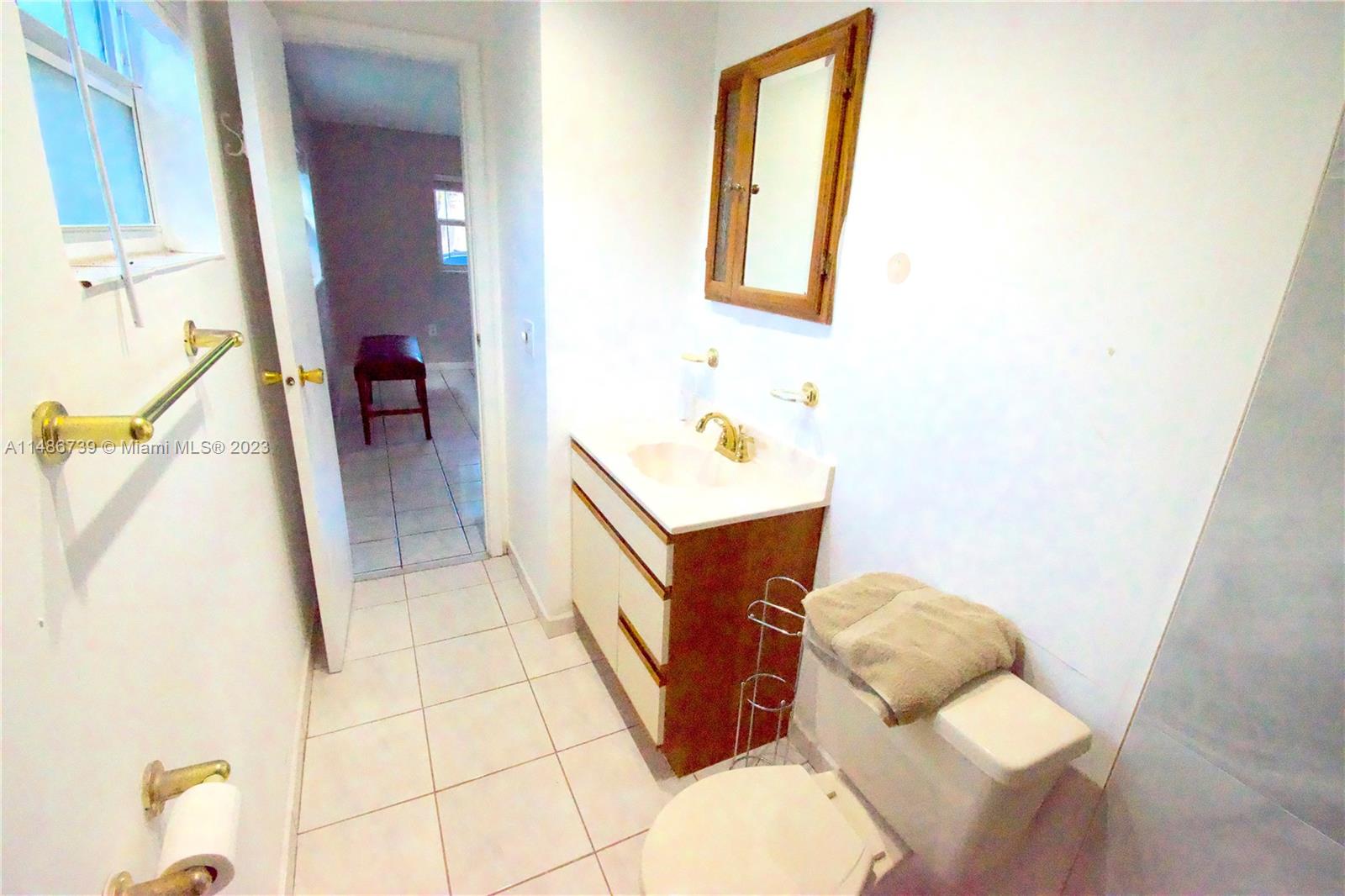 6560 Northwest 30th Street Sunrise, FL 33313 - Photo 14 of 46 a bathroom with a sink toilet and mirror