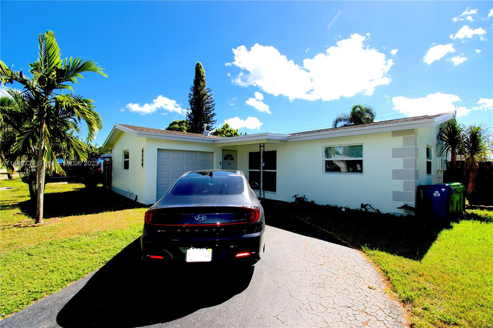 6560 Northwest 30th Street Sunrise, FL 33313 - Photo 2 of 46 a front view of a house with a yard
