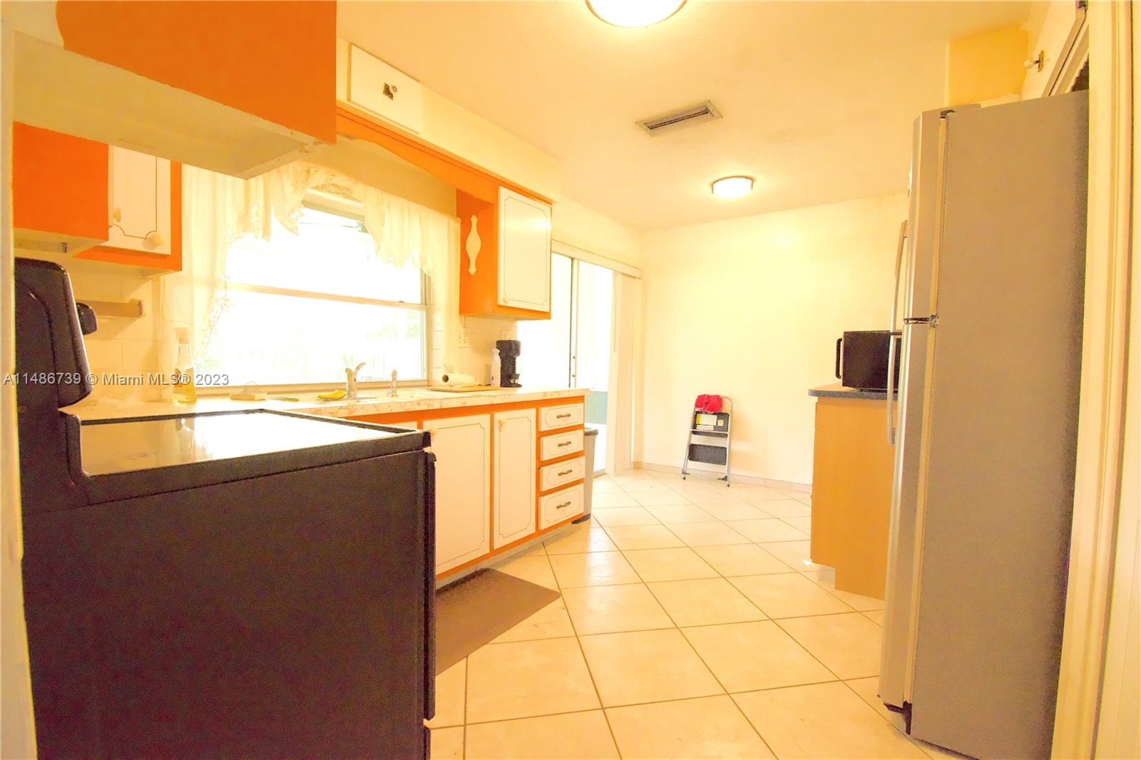 6560 Northwest 30th Street Sunrise, FL 33313 - Photo 21 of 46 a view of a kitchen with a sink and a refrigerator