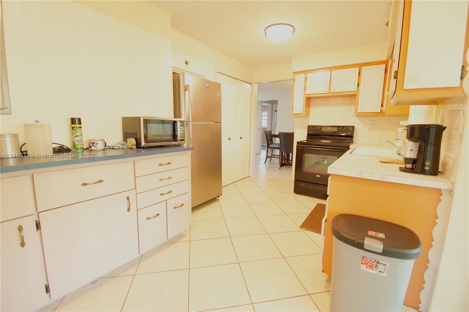 6560 Northwest 30th Street Sunrise, FL 33313 - Photo 22 of 46 a kitchen with a sink a stove and refrigerator