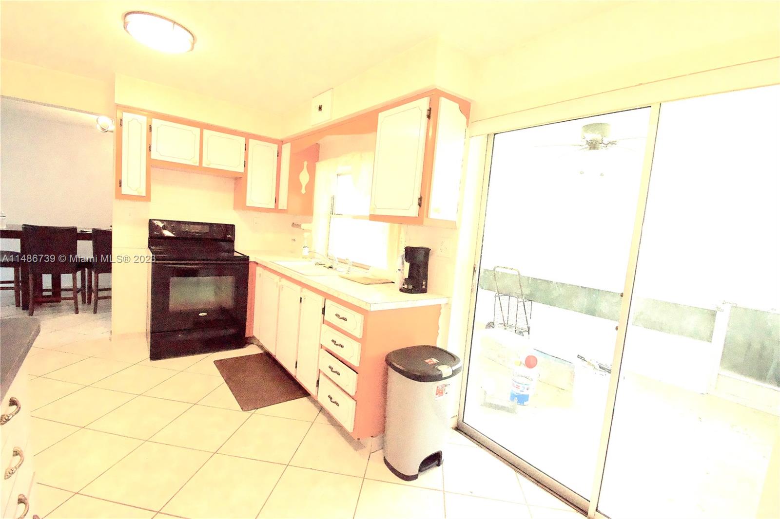 6560 Northwest 30th Street Sunrise, FL 33313 - Photo 23 of 46 a kitchen with a sink and a refrigerator