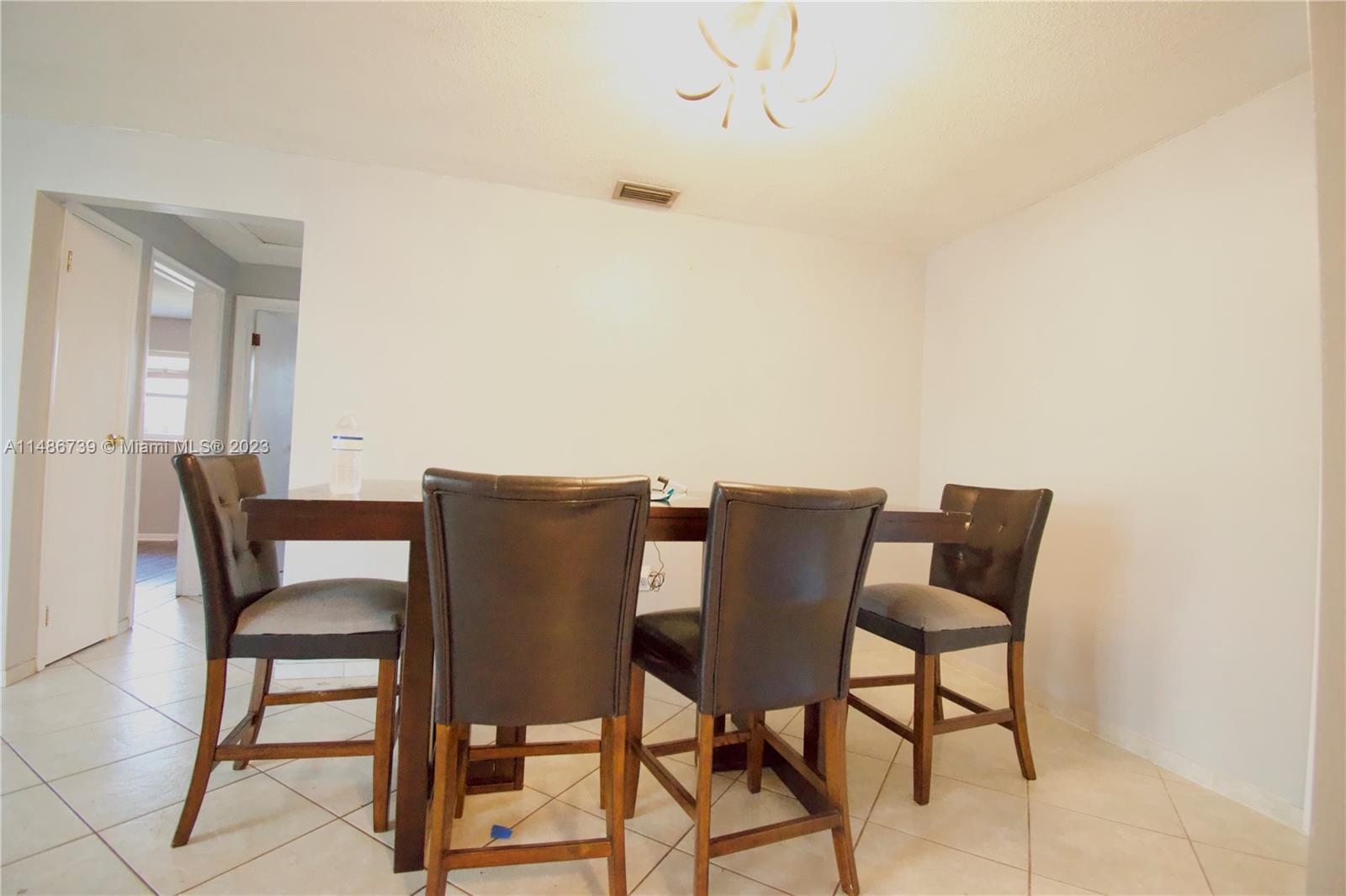 6560 Northwest 30th Street Sunrise, FL 33313 - Photo 25 of 46 a view of a dining room with furniture and wooden floor