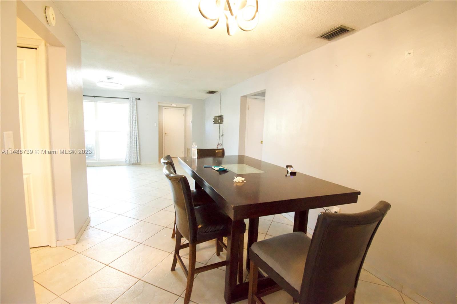 6560 Northwest 30th Street Sunrise, FL 33313 - Photo 26 of 46 a view of a dining room with furniture