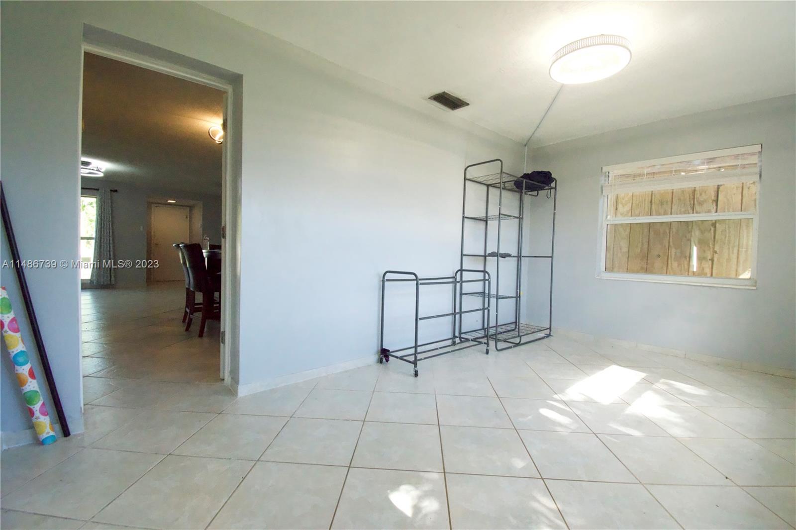 6560 Northwest 30th Street Sunrise, FL 33313 - Photo 28 of 46 a view of a livingroom with a furniture and chandelier fan