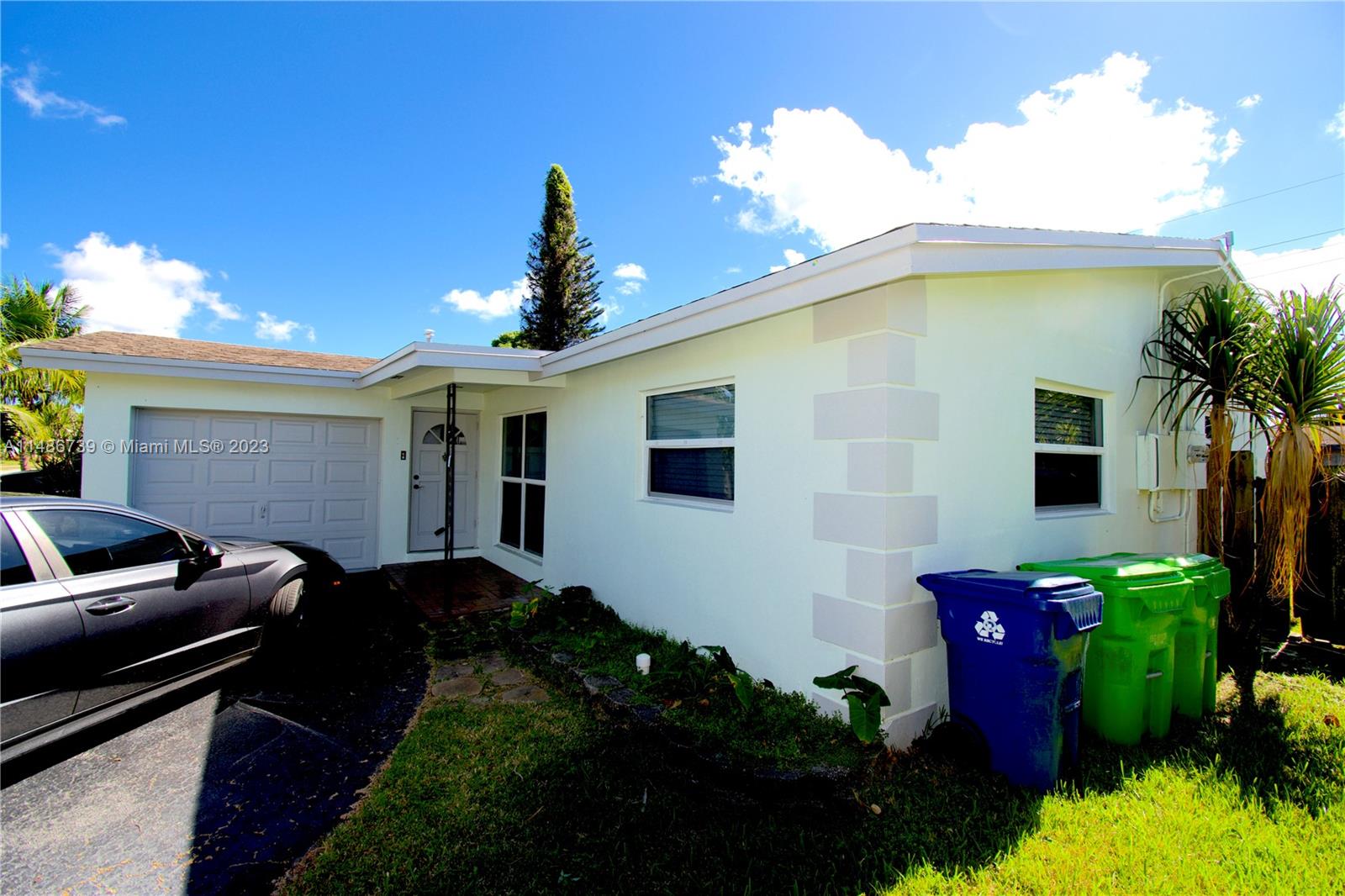6560 Northwest 30th Street Sunrise, FL 33313 - Photo 3 of 46 a front view of a house with garden