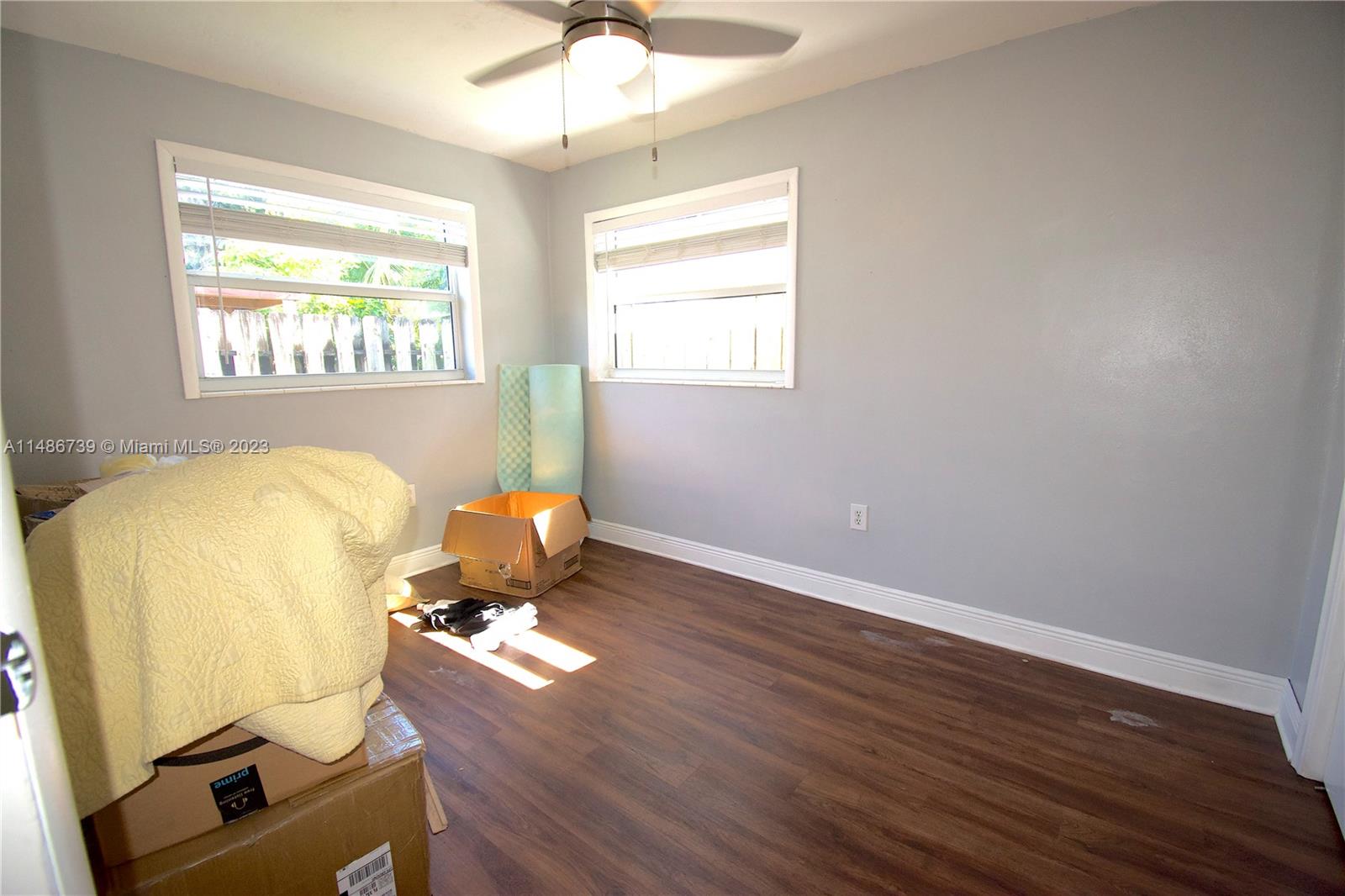6560 Northwest 30th Street Sunrise, FL 33313 - Photo 37 of 46 a room with wooden floor and windows