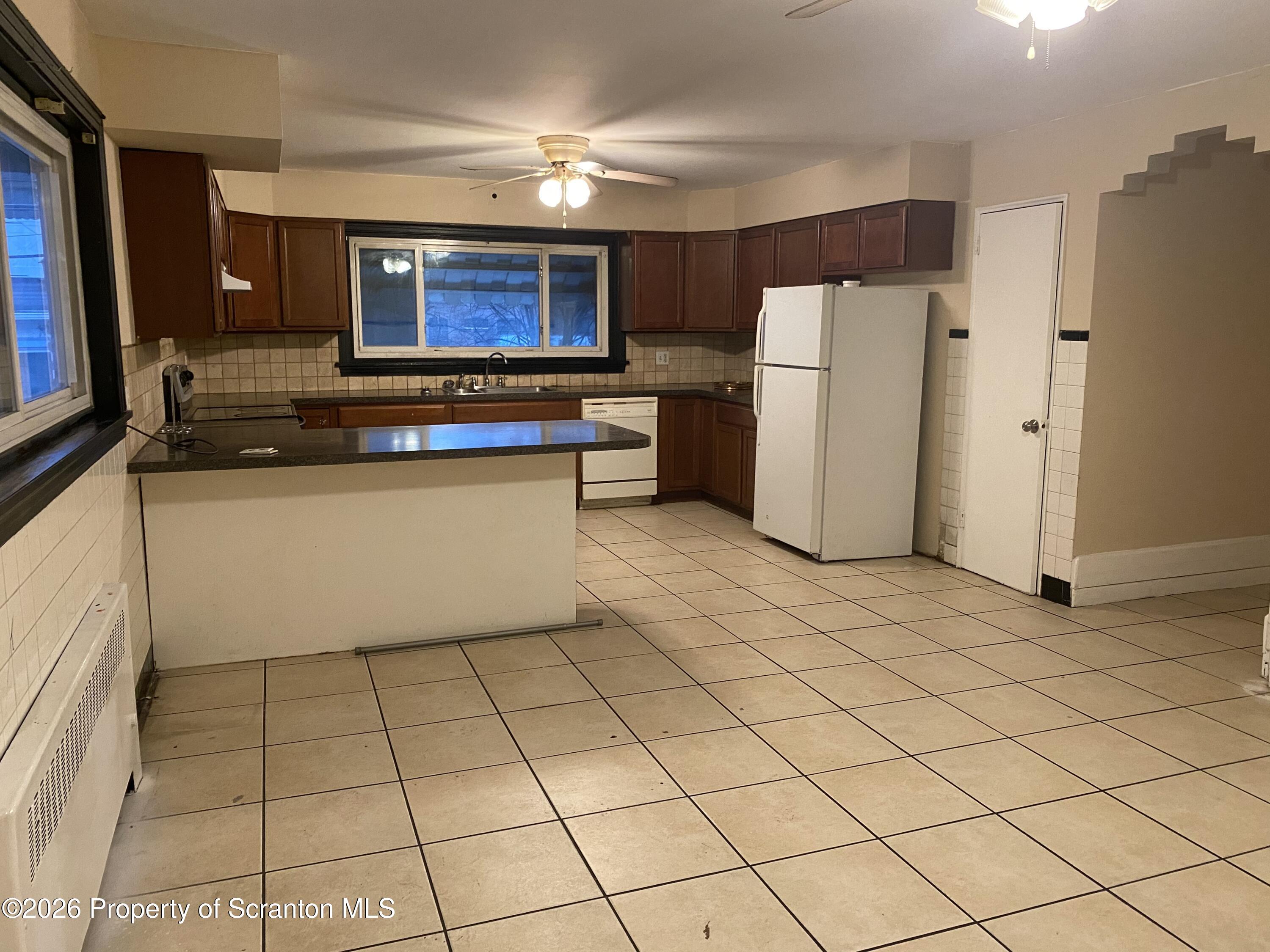 414 Orchard Street Scranton, PA 18505 - Photo 7 of 20 a kitchen with stainless steel appliances granite countertop a refrigerator and a stove top oven