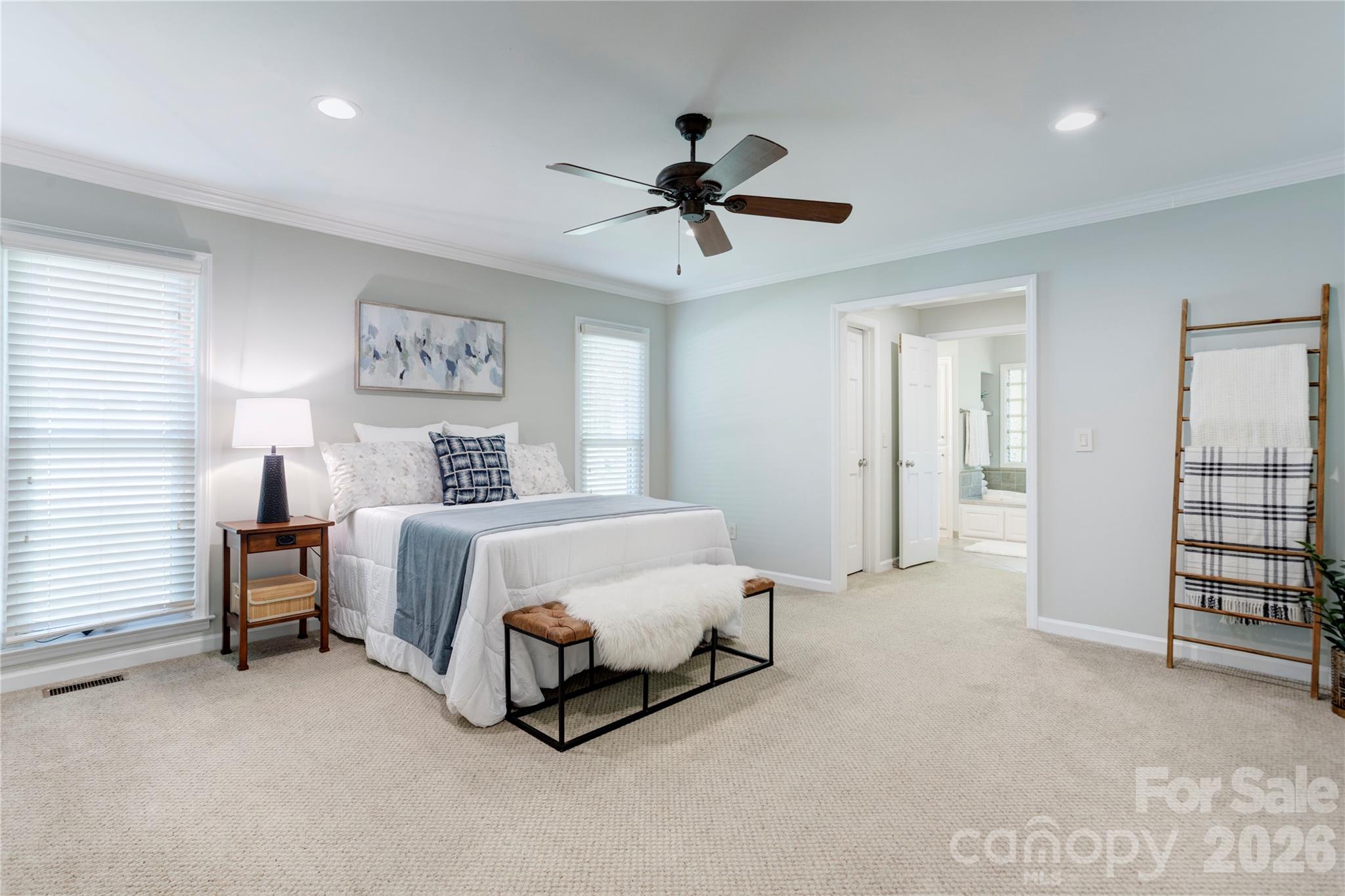 1188 Fawn Ridge Road Northwest Concord, NC 28027 - Photo 20 of 38 a spacious bedroom with a bed and a chandelier