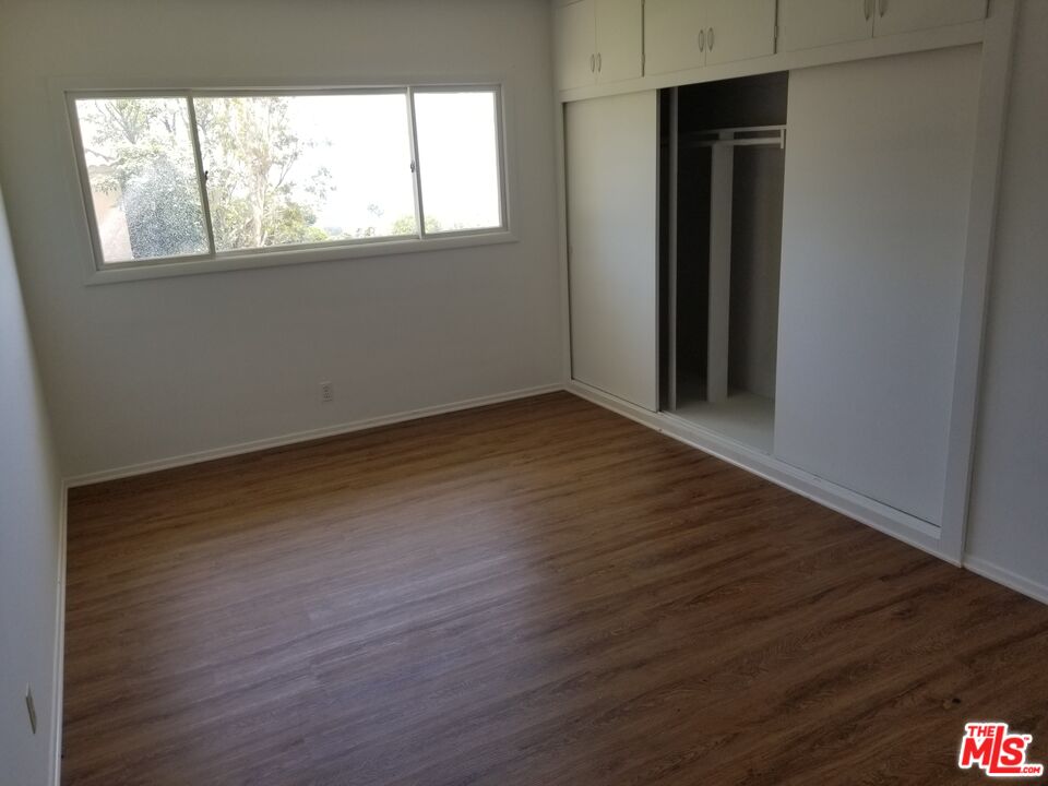 20490 Seaboard Road Malibu, CA 90265 - Photo 31 of 50 an empty room with wooden floor and windows
