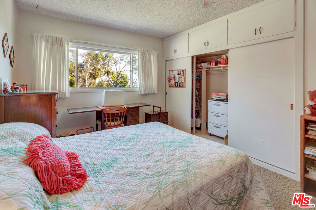 20490 Seaboard Road Malibu, CA 90265 - Photo 32 of 50 a bedroom with a large bed and a window