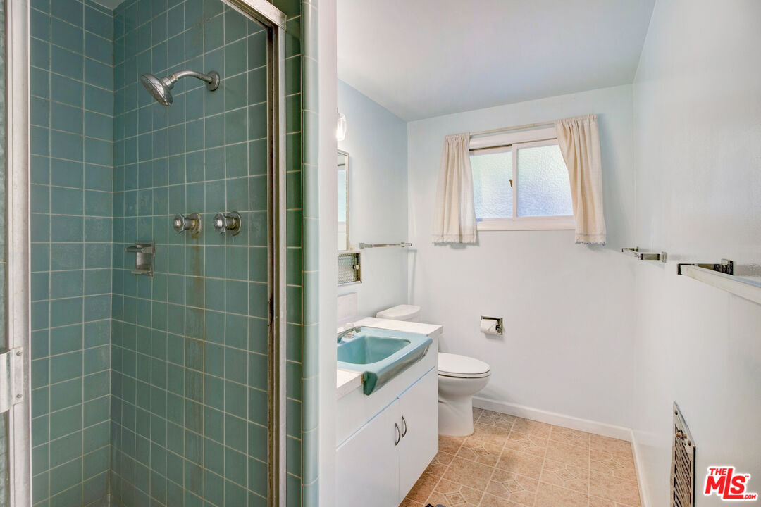 20490 Seaboard Road Malibu, CA 90265 - Photo 37 of 50 a bathroom with a toilet a sink and shower