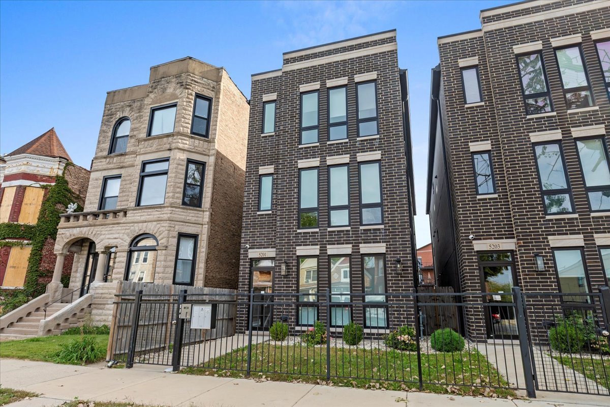 5201 South Wabash Avenue, Unit 3 Chicago, IL 60615 - Photo 1 of 11 a front view of a residential apartment building with a yard