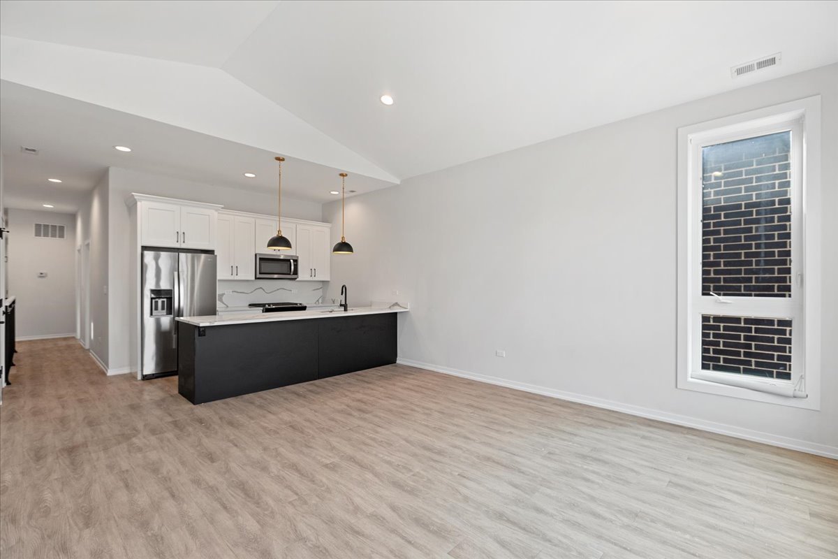 5201 South Wabash Avenue, Unit 3 Chicago, IL 60615 - Photo 3 of 11 a living room with a couch and a window
