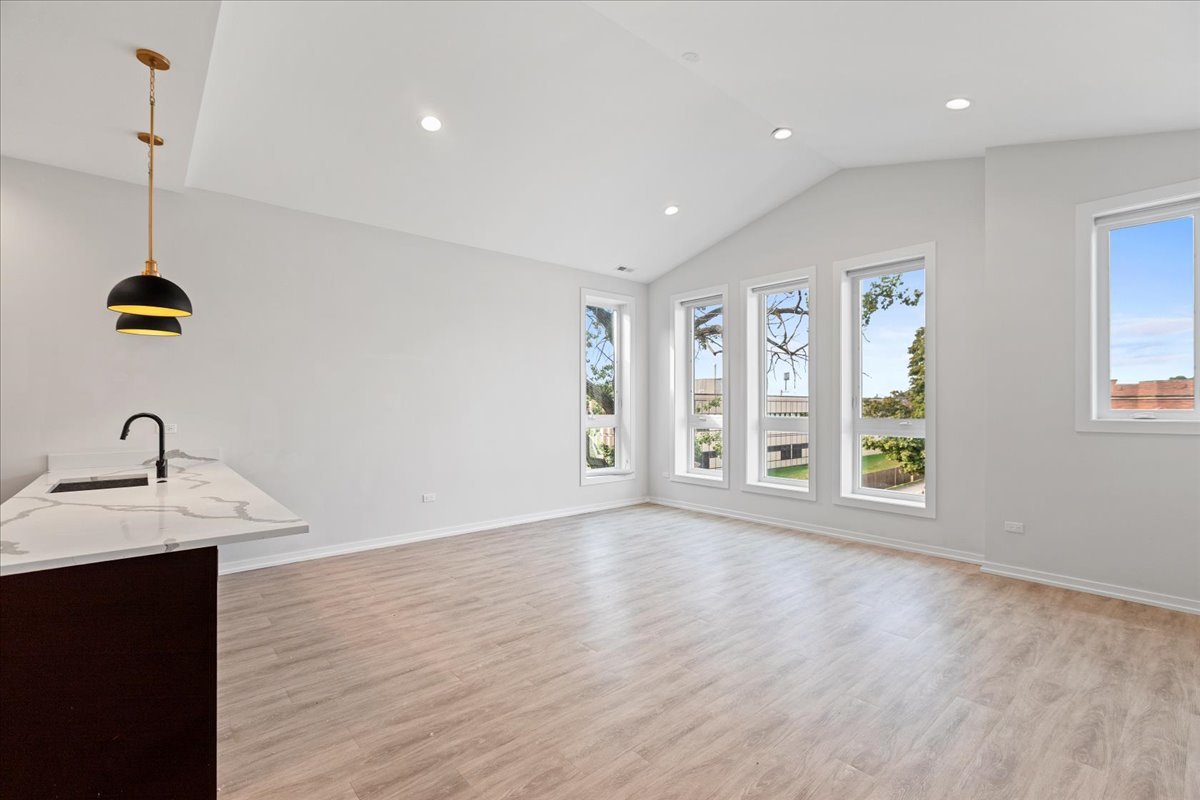 5201 South Wabash Avenue, Unit 3 Chicago, IL 60615 - Photo 4 of 11 a view of a room with wooden floor ceiling fan and window