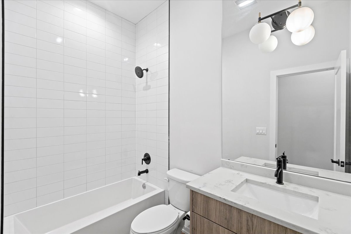 5201 South Wabash Avenue, Unit 3 Chicago, IL 60615 - Photo 7 of 11 a bathroom with a sink a toilet and bathtub