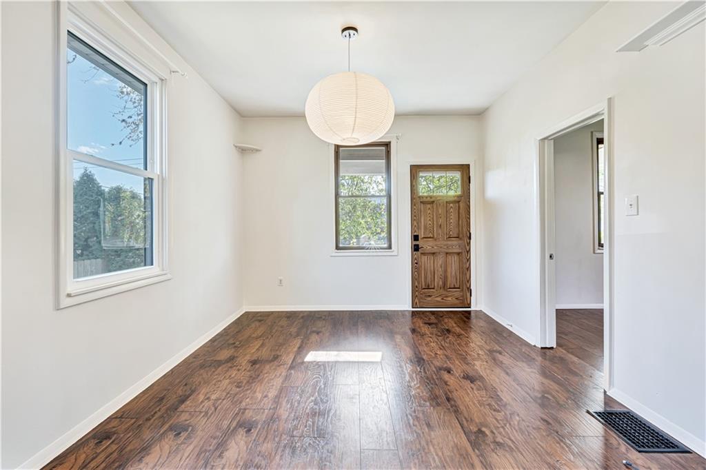 5504 Jane Pittsburgh, PA 15225 - Photo 4 of 27 an empty room with wooden floor cabinet and windows