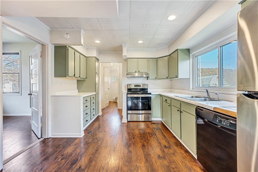 5504 Jane Pittsburgh, PA 15225 - Photo 8 of 27 a large kitchen with stainless steel appliances lots of counter space and wooden floor