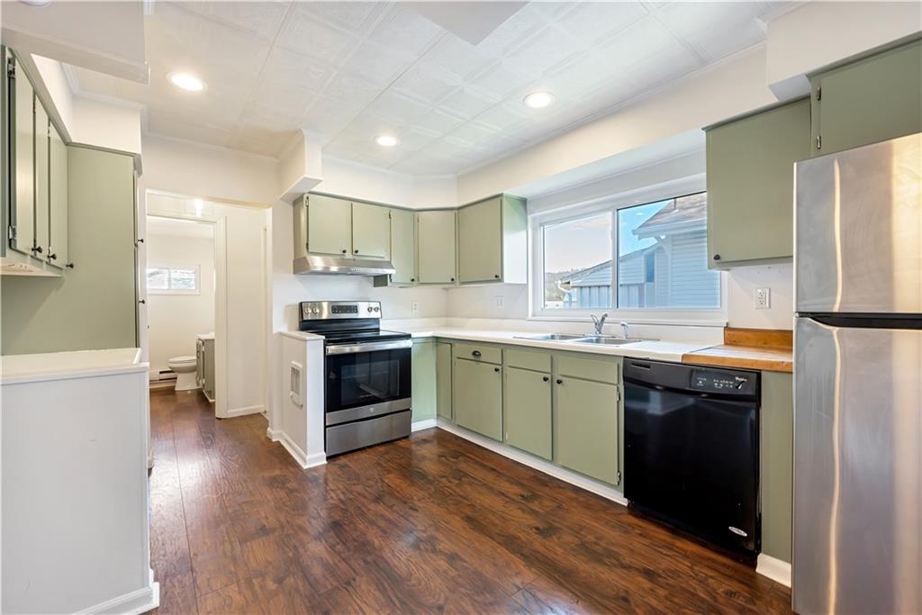 5504 Jane Pittsburgh, PA 15225 - Photo 10 of 27 a kitchen with a sink a microwave a stove and refrigerator